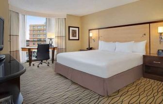 spacious king room with TV and work area ideal for working remotely at Hilton Rosemont/Chicago O'Hare.