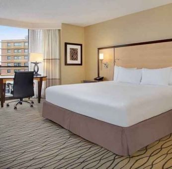 spacious king room with TV and work area ideal for working remotely at Hilton Rosemont/Chicago O'Hare.