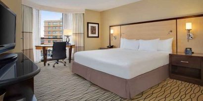 spacious king room with TV and work area ideal for working remotely at Hilton Rosemont/Chicago O'Hare.