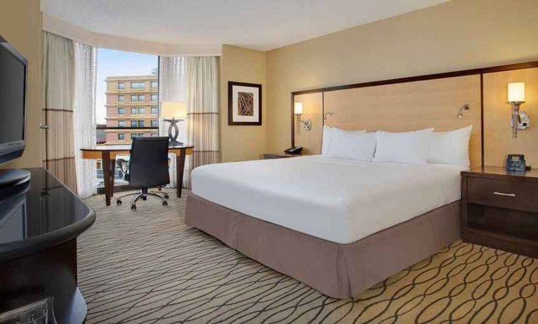 spacious king room with TV and work area ideal for working remotely at Hilton Rosemont/Chicago O'Hare.