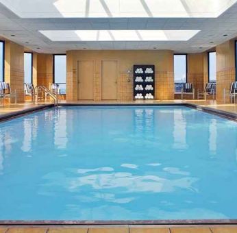 lovely indoor pool with surround seating area at Hilton Rosemont/Chicago O'Hare.