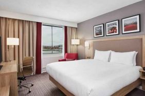 Bright king bedroom with desk and TV screen at the Hilton Garden Inn Dublin Custom House.