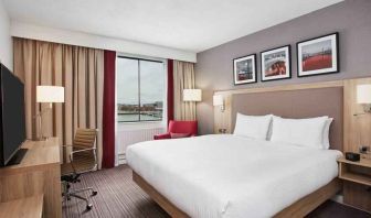 Bright king bedroom with desk and TV screen at the Hilton Garden Inn Dublin Custom House.