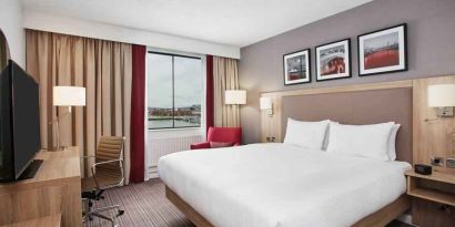 Bright king bedroom with desk and TV screen at the Hilton Garden Inn Dublin Custom House.