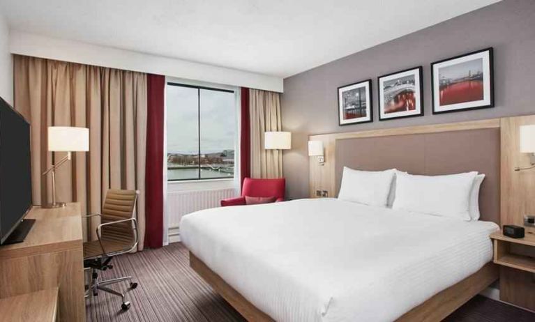 Bright king bedroom with desk and TV screen at the Hilton Garden Inn Dublin Custom House.