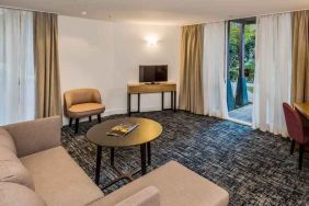 Suite living room with sofa and desk at the Morrison, a DoubleTree by Hilton Hotel.