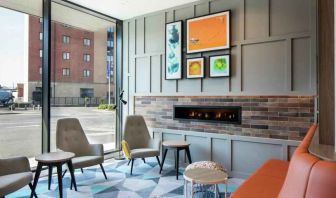 Lobby workspace by the fireplace at the Hampton by Hilton Belfast City Centre.