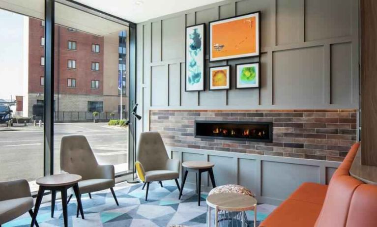 Lobby workspace by the fireplace at the Hampton by Hilton Belfast City Centre.