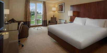 King bedroom with desk at the Hilton Belfast Templepatrick Golf & Country Club.