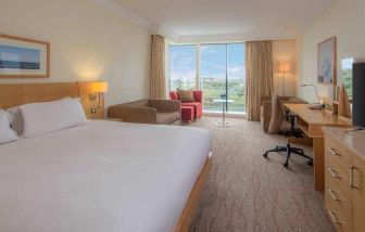 Large king suite with working station at the Hilton Dublin Airport.
