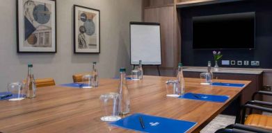 Small meeting room with square table at the Hilton Dublin Airport.