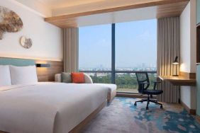 King bedroom with desk along the window at the Hilton Garden Inn Jakarta Taman Palem.