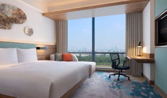 King bedroom with desk along the window at the Hilton Garden Inn Jakarta Taman Palem.