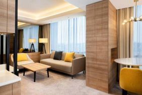 Spacious living room with working station in a king suite at the Hilton Garden Inn Jakarta Taman Palem.