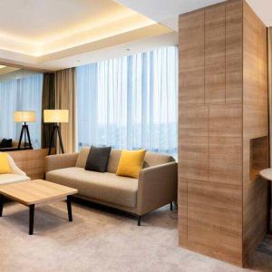 Spacious living room with working station in a king suite at the Hilton Garden Inn Jakarta Taman Palem.