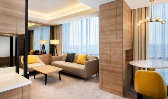 Spacious living room with working station in a king suite at the Hilton Garden Inn Jakarta Taman Palem.