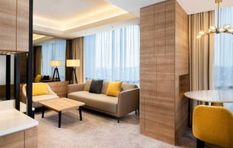 Spacious living room with working station in a king suite at the Hilton Garden Inn Jakarta Taman Palem.