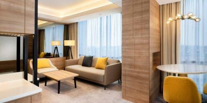 Spacious living room with working station in a king suite at the Hilton Garden Inn Jakarta Taman Palem.