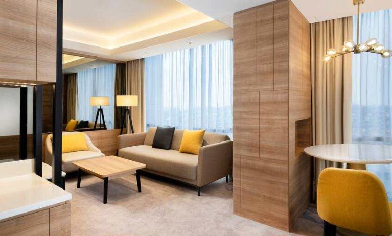 Spacious living room with working station in a king suite at the Hilton Garden Inn Jakarta Taman Palem.