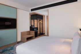 Comfortable king size bed in a king guestroom at the Hilton Garden Inn Jakarta Taman Palem.