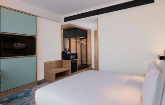 Comfortable king size bed in a king guestroom at the Hilton Garden Inn Jakarta Taman Palem.