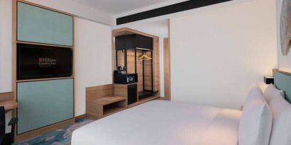 Comfortable king size bed in a king guestroom at the Hilton Garden Inn Jakarta Taman Palem.