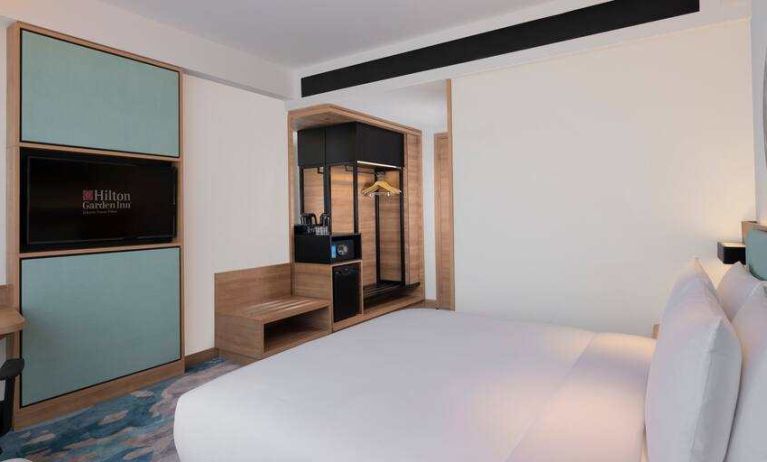 Comfortable king size bed in a king guestroom at the Hilton Garden Inn Jakarta Taman Palem.