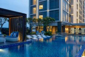 Beautiful outdoor pool area with lounges at the Hilton Garden Inn Jakarta Taman Palem.