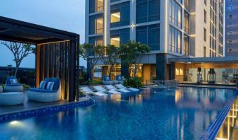 Beautiful outdoor pool area with lounges at the Hilton Garden Inn Jakarta Taman Palem.