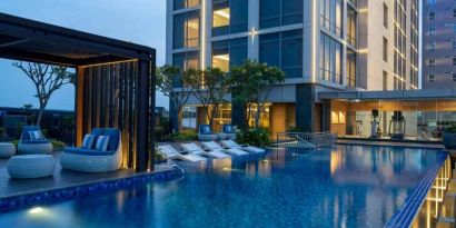 Beautiful outdoor pool area with lounges at the Hilton Garden Inn Jakarta Taman Palem.