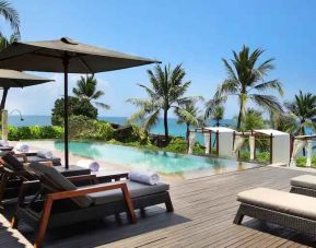 Outdoor pool with lounges at the Hilton Bali Resort.