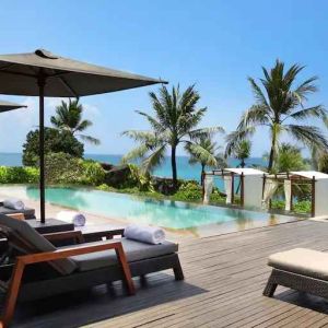 Outdoor pool with lounges at the Hilton Bali Resort.