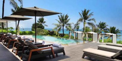 Outdoor pool with lounges at the Hilton Bali Resort.