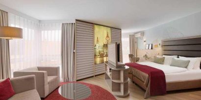 Stylish king suite with working station at the DoubleTree by Hilton Hannover Schweizerhof.