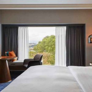 King guestroom with working station at the Hilton Frankfurt City Centre.