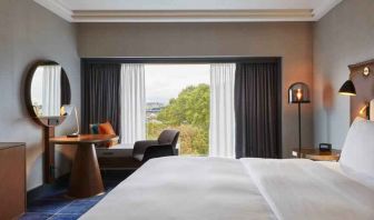 King guestroom with working station at the Hilton Frankfurt City Centre.