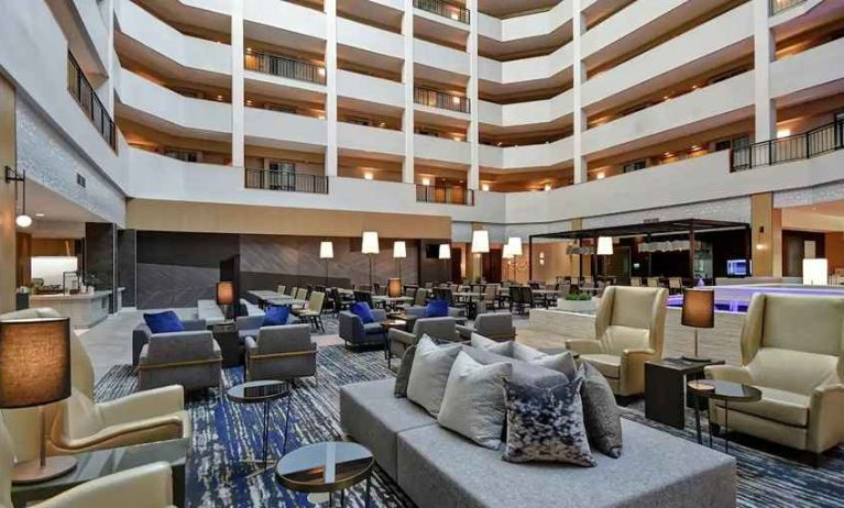 comfortable and bright-lit lounge and coworking space at Embassy Suites by Hilton Raleigh Durham Research Triangle.