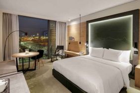 King bedroom with desk along the window at the Hilton Munich Airport.