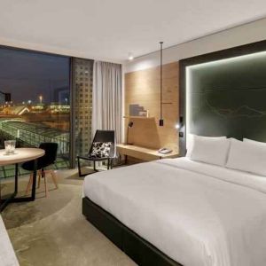 King bedroom with desk along the window at the Hilton Munich Airport.