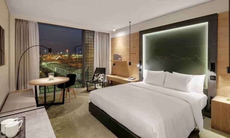 King bedroom with desk along the window at the Hilton Munich Airport.