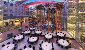 Spacious outdoor patio with palms at the Hilton Munich Airport.