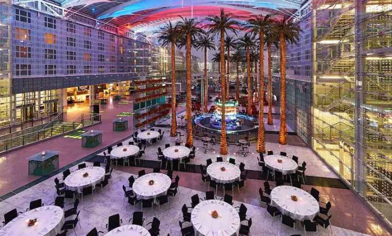 Spacious outdoor patio with palms at the Hilton Munich Airport.