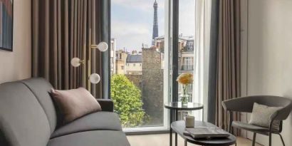 Living room overlooking the tour eiffel at the Canopy by Hilton Paris Trocadero.