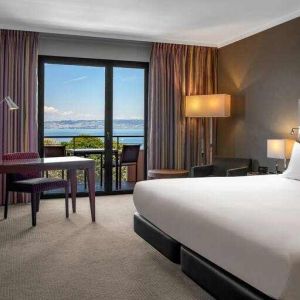 King bedroom with lake view at the Hilton Evian-les-Bains.