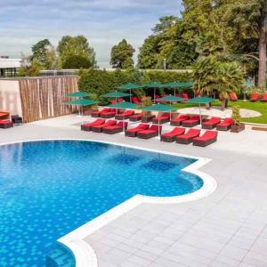 Outdoor pool with lounges at the Hilton Evian-les-Bains.