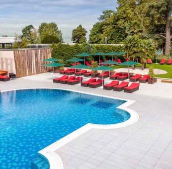 Outdoor pool with lounges at the Hilton Evian-les-Bains.