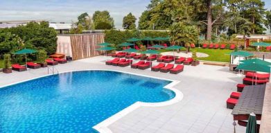 Outdoor pool with lounges at the Hilton Evian-les-Bains.