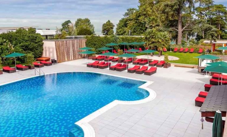 Outdoor pool with lounges at the Hilton Evian-les-Bains.