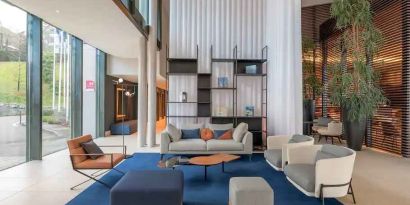 Bright lobby workspace with sofas at the Hilton Evian-les-Bains.