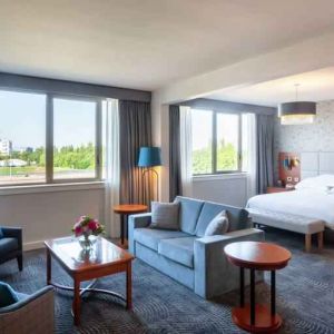 Spacious king suite with living room and working station at the Hilton Strasbourg.